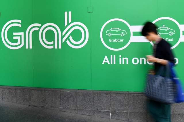 Malaysia threatens ride-hailing firm Grab with $21 million fine