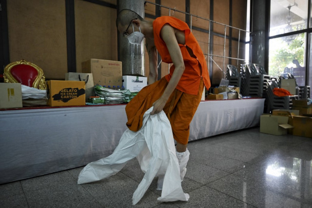Thai monks don protective gear as Covid cases surge